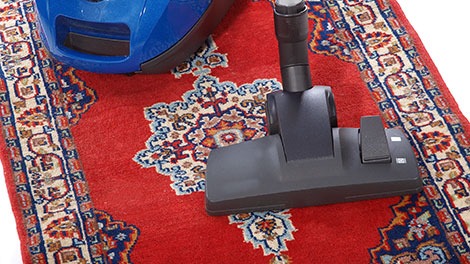 Technician cleaning living room carpet
